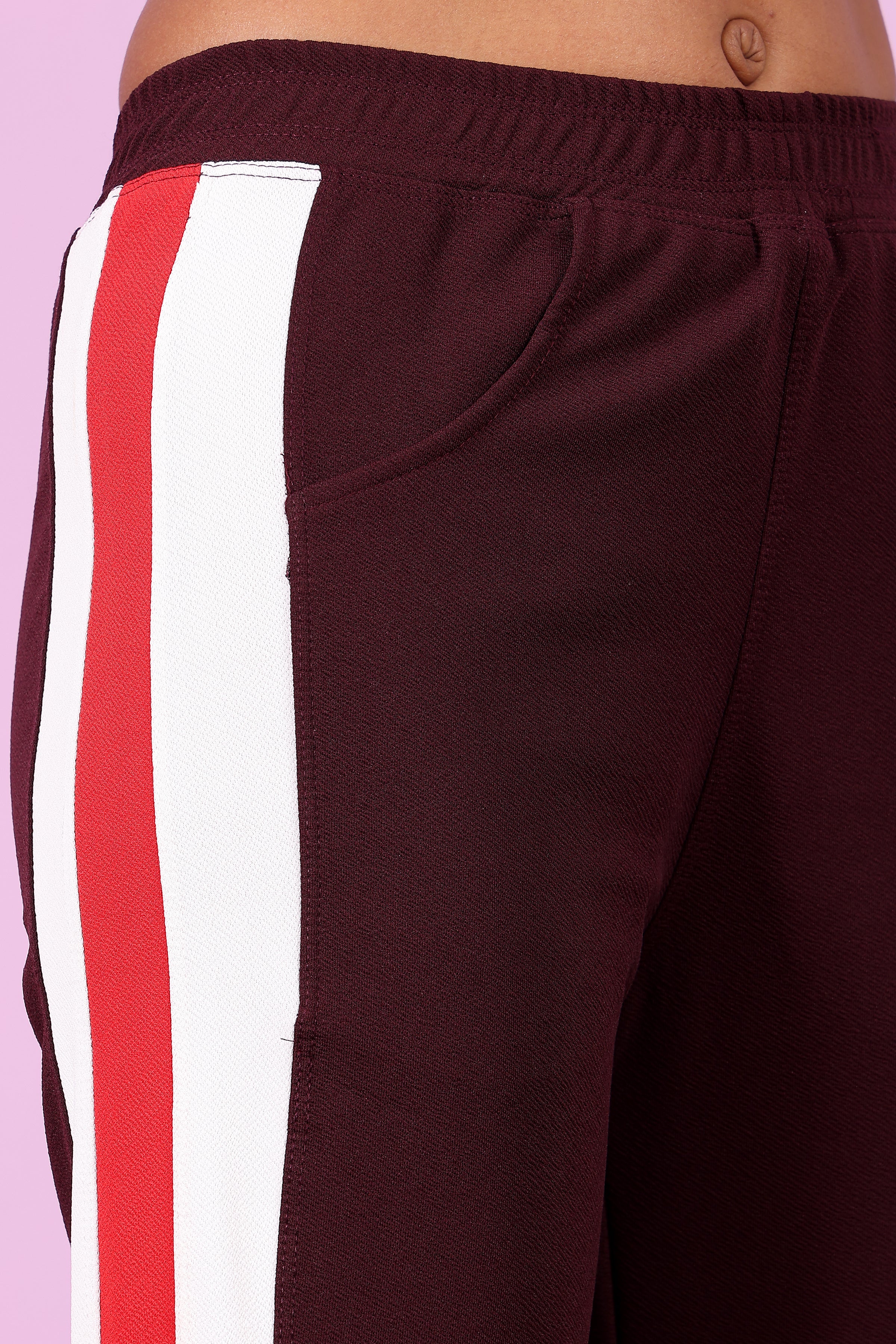 Zicada Maroon pants with red and white stripes on a light purple background